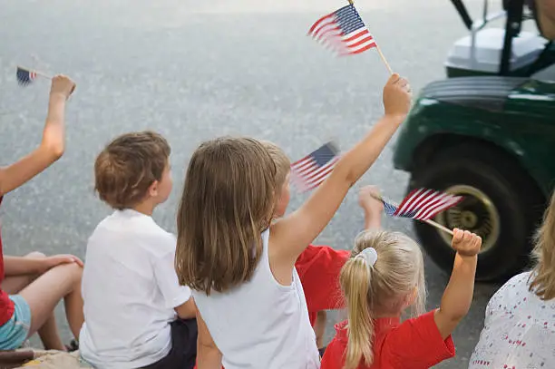 Kids waving flags at a parade