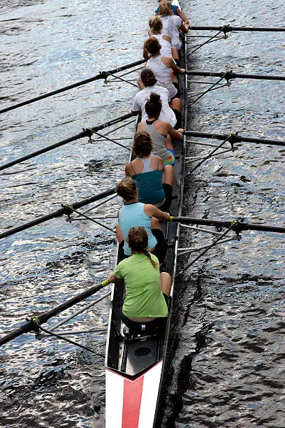 women crew team race on river
