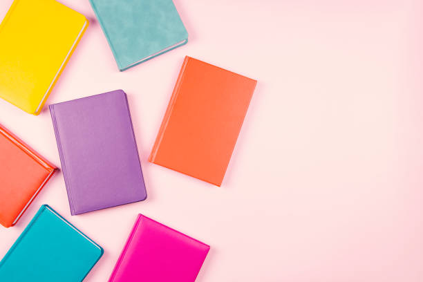 istock Colorful hardcover books on pastel pink background. Top view, copy space for text 1399953117