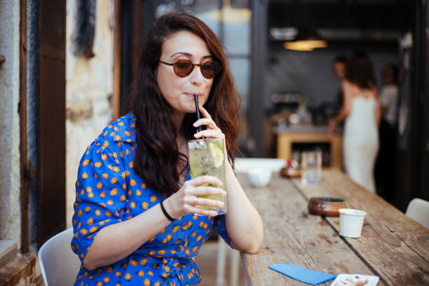 istock Woman drinking lemonade at cafe on summer day 1399957220