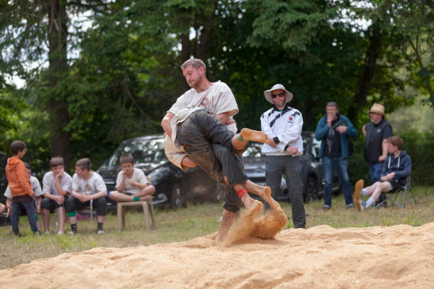 Pleyber-Christ, France - May 29 2022: Two Breton wrestlers (gouren) during a match taking place on sawdust.