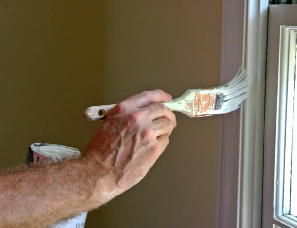 Man Painting an Interior Window Frame stock photo