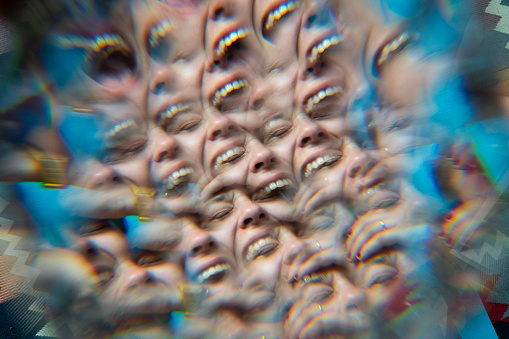 Multiple image of a female laughing portrait with a prism