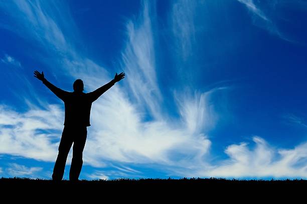 istock A man stretching his arms in faith 139996207