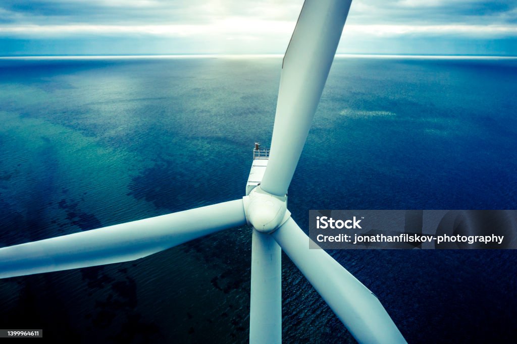 Wind turbines at sea Aerial drone shot of of coastal wind turbines at a wind farm within the capital city, Copenhagen, Denmark. Green energy is the hot alternative to fossil fuel and the world is now preparing for this transistion. Images shot with drone Sustainable Energy Stock Photo
