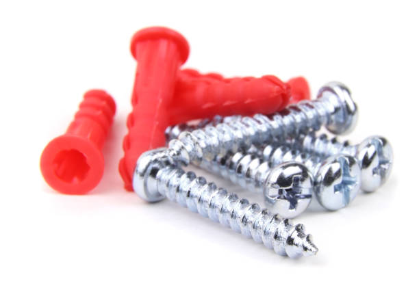 Plastic dowels and metal screws isolated on a white background.Wall plugs.