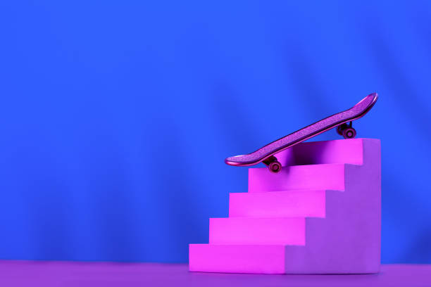 skate in pink on the stairs, as a symbol of extreme sports, skateboarding, parkour, roller skates on a blue background with a place for text. - roller skate imagens e fotografias de stock