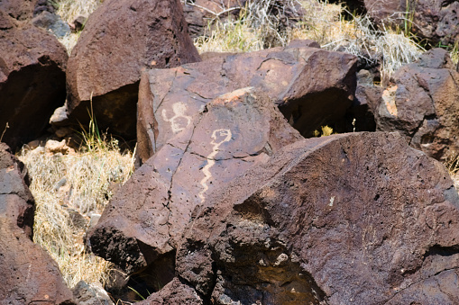 Albuquerque, New Mexico,  USA, Oct 1, 2021: designs and symbols carved on Volcanic Rocks in Petroglyph National Monument.