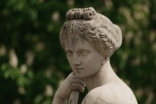 Warsaw, Poland - MAY 12, 2022: The headshot of an old female sculpture in Royal Baths Park, Lazienki Park