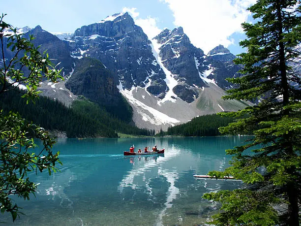 Canoe on Lake Moraine with glaciers in the Rocky Mountains, Alberta, Canada