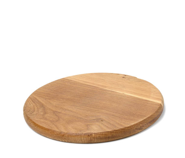 istock empty round wooden kitchen cutting board, pizza stand. White background 1399969400