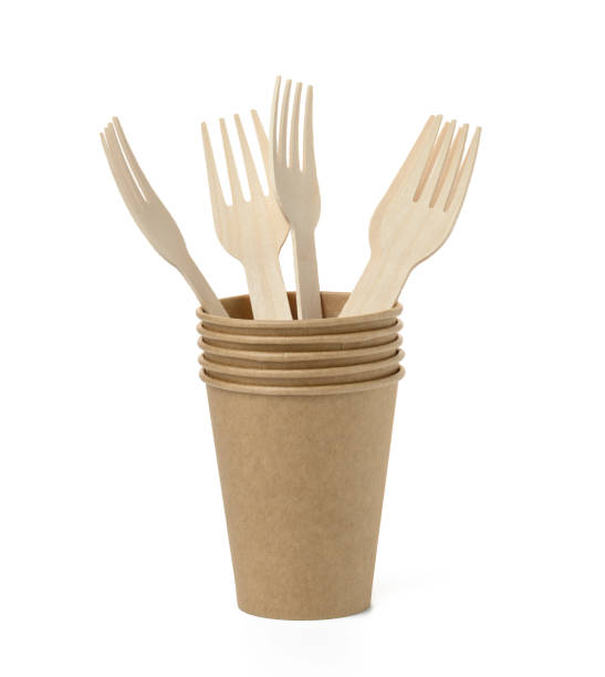 istock Brown paper cups, wooden fork on a white background. Recyclable garbage 1399969435