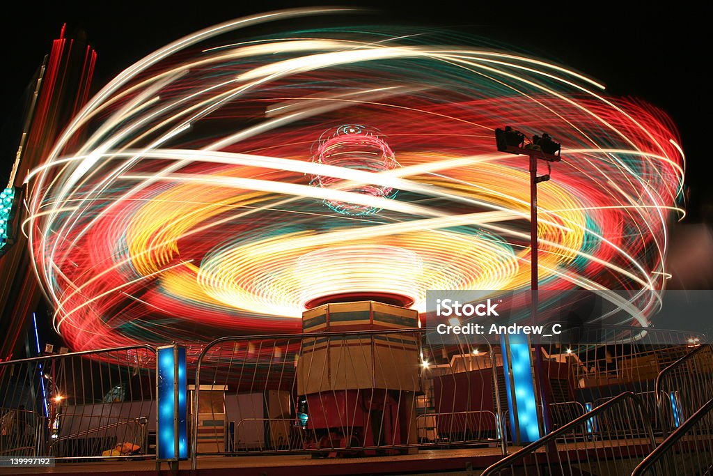 Carnival Ride A long exposure of a thrill ride. Amusement Park Stock Photo