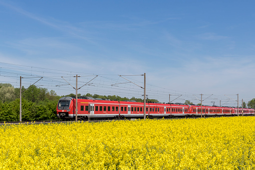 Bavaria, Germany, Mai 2022, DB, Deutsche Bahn, german train, red regional train drives through a landscape in spring time