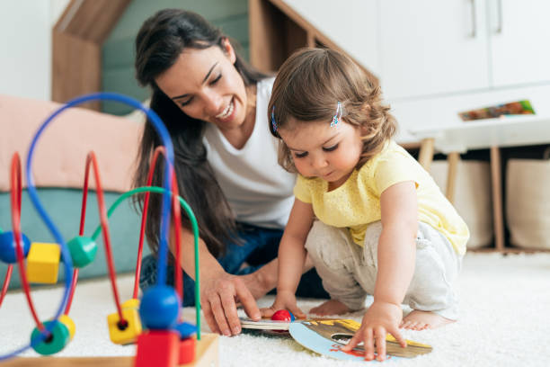 istock Mother and daughter reading book 1399975534