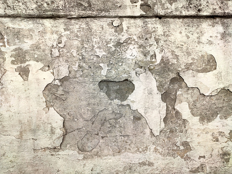 Grey Concrete Texture old wall background with peeling paint, scratches and cracks