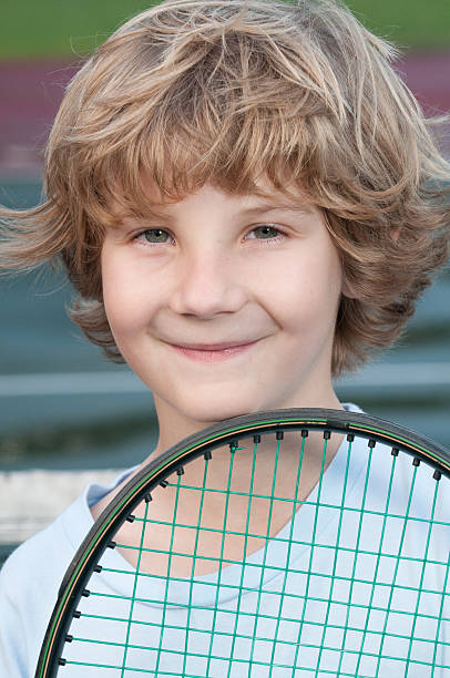 istock Blond boy holding a tennis racket 139998079