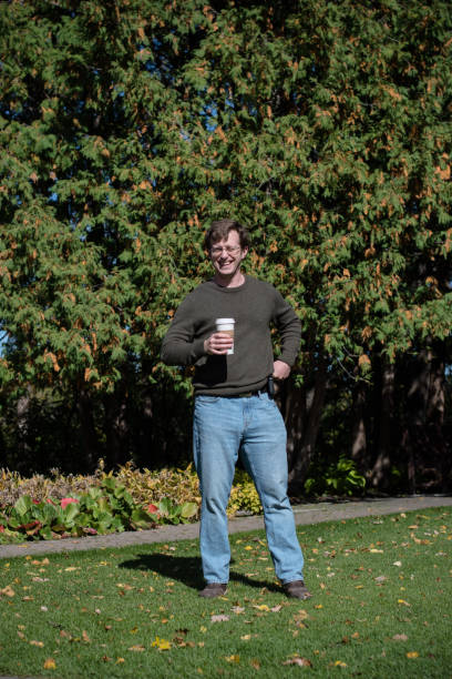 istock Confident Man with a coffee, squints in the sunlight. 1399980882