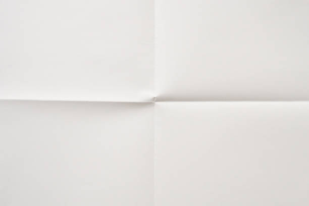 Close-up of blank torn piece of white paper isolated on white background with clipping path.