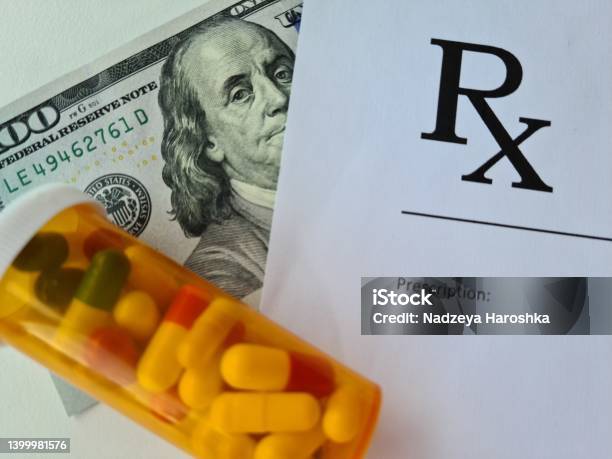 Dollar Bill And Doctor Prescription With Pills Lie On Doctor Table In Clinic Closeup Stock Photo - Download Image Now