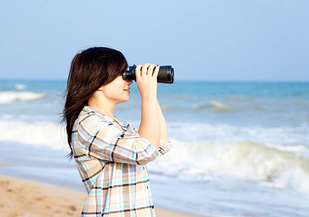 istock Girl with binocular at the beach. 139998214