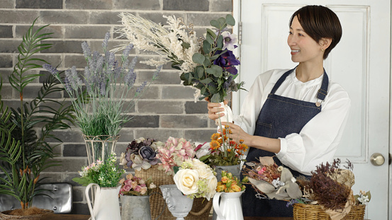 young asian woman working in the flower shop