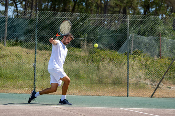 istock Tennis player hitting backhand at ball 1399989583