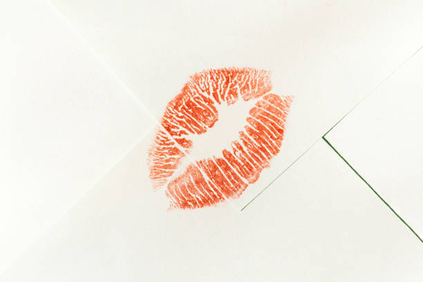 Red lipstick kiss mark on white envelope