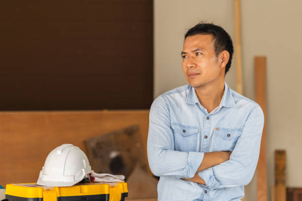 istock Relaxing male carpenter sitting on workbench, Carpenter working on woodworking machines in carpentry shop 1399996416