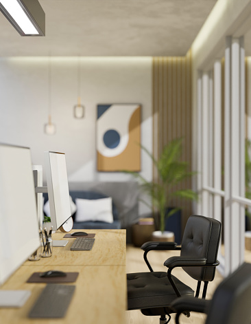 Modern office room interior design with pc computer mockup and office supplies on wood table, office armchairs over blurred modern resting area in background. 3d rendering, 3d illustration