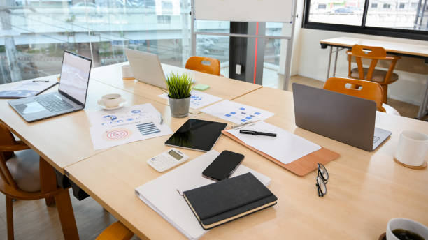 istock Messy office meeting table with notebook laptop, tablet and stuff 1400000643