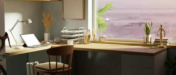 istock Modern home office workspace with tablet mockup on wooden corner tabletop near the window. 1400000647