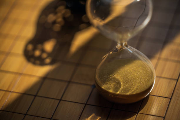 istock Hour glass with gold sand in dramatic lighting 1400000734