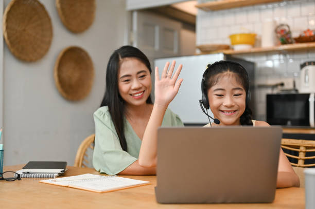 istock Young girl having an online class, learning on laptop computer at home 1400002231