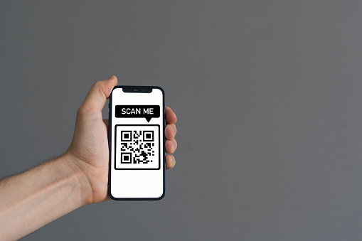 person hand hold smartphone with scanned qr code