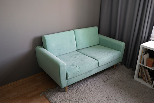 simple light grey sofa couch at home, minimalistic apartment style