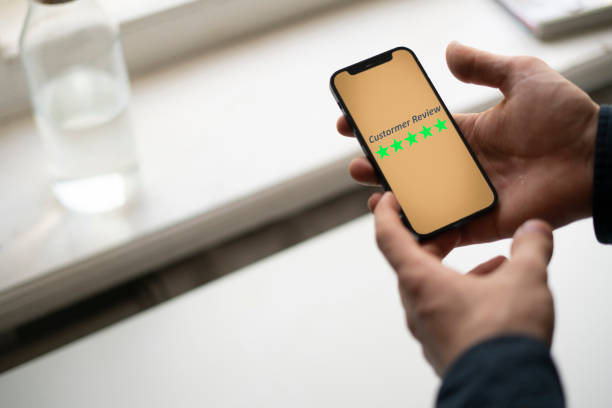 smartphone screen with five star quality review, positive feedback