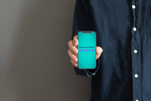 smartphone screen with five star quality review, positive feedback