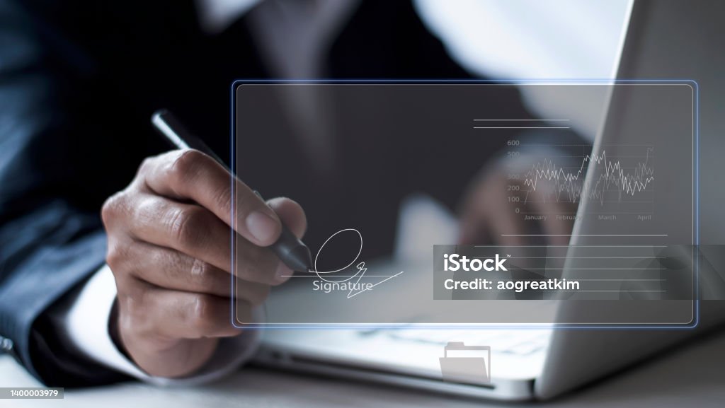 businessman use electronic pen sign signature on electronic  E-signing, data sheet document management, paperless office concept. Businessman using stylus pen signing e document on digital tablet. Signing Stock Photo