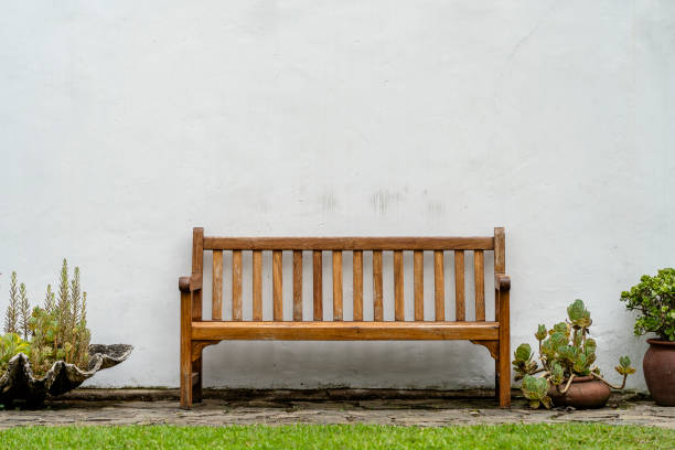 istock Wooden bench front of a white wall 1400006602
