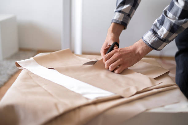 istock professional tailor cut textile with scissors in the shop 1400009749