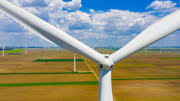 istock Above close view on large wind power turbine as standing among agricultural fields, generating clean renewable electrical energy 1400011635
