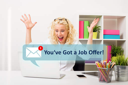 Excited and happy girl receiving message with a new job offer