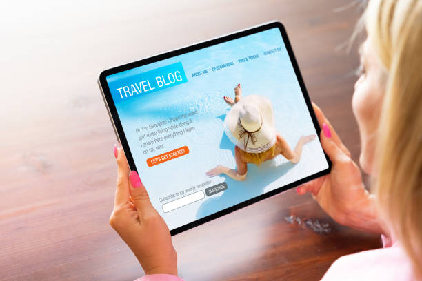 istock Woman viewing travel blog website on tablet computer 1400016438
