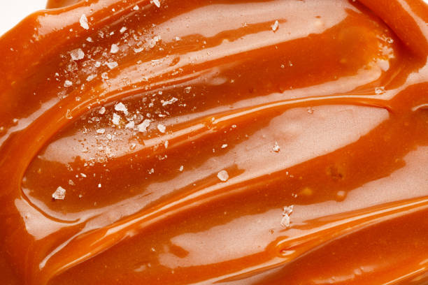 istock Liquid salted caramel syrup. Background of salted caramel paste. Texture Close up, top view. 1400016692