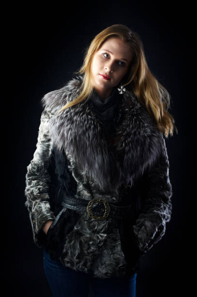 istock Young attractive woman in fur coat over black 1400019192