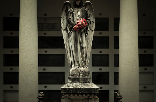 Old statue of angel in cemetery