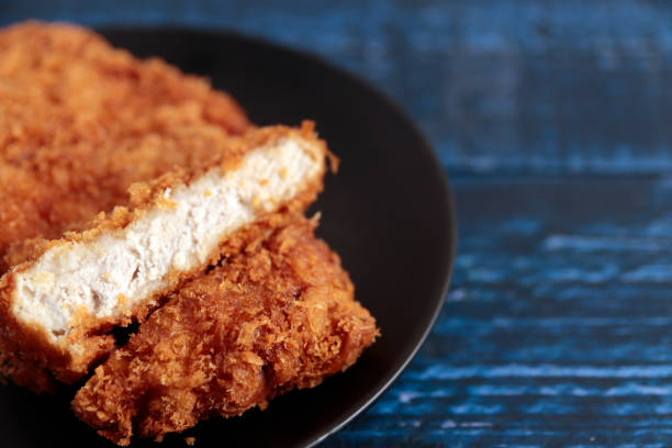 istock High-calorie pork katsuretsu fried in oil on a blue table 1400022076