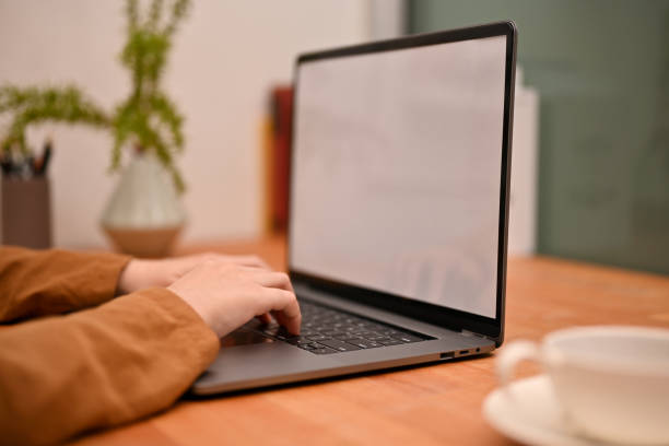 istock Female office employee remote working at home, typing on keyboard, using laptop computer. 1400022397