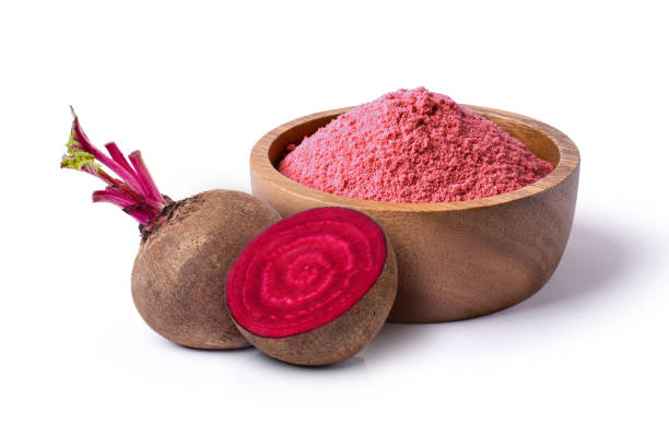 Beetroot (beet root) powder in wooden bowl with fresh fruit isolated on white stock photo
